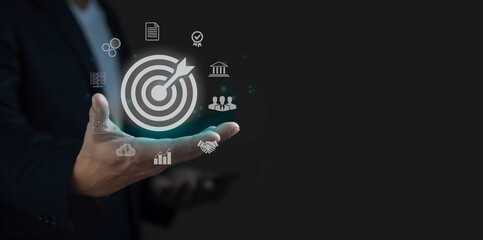 A person is holding a tablet with a picture of a target on it