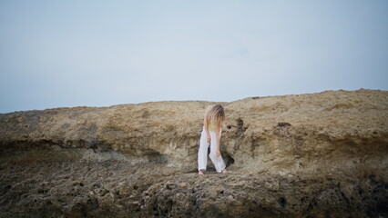 Dance artist moving body sensually on rocks summer day. Romantic girl dancing 