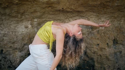 Fotobehang Flexible girl practicing contemporary choreography in front sandy rock close up © stockbusters