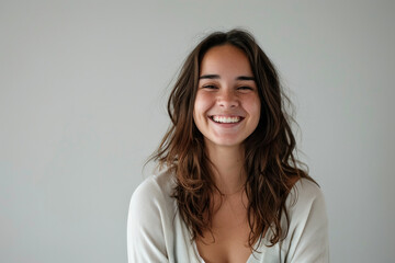 Obraz premium Beautiful young woman smiling portrait on white background isolated on gray for stock photo