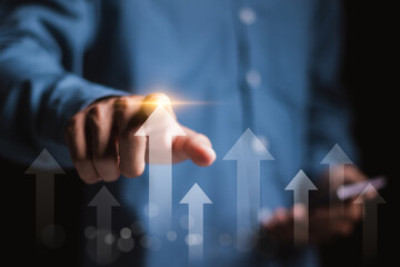 Marketing business growth concept. Business graph analysis. Business development to success, financial plan and strategy. Businessman touching arrow up icon on virtual screen.