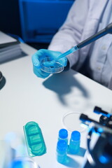 Fototapeta premium A chemist is testing a newly discovered chemical using a variety of scientific equipment in his lab, The working atmosphere in the laboratory while scientists are doing research.