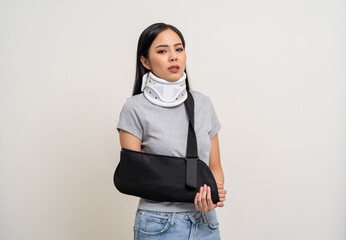 Depressed upset woman suffering from pain. Broken arm. Asian woman put on plaster bandage cast...