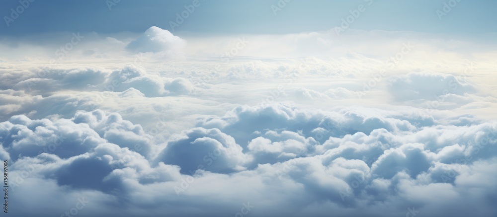 Poster an atmospheric view of a cloudy sky above a natural landscape, with cumulus clouds stretching toward