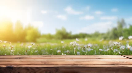 Deurstickers Wooden table top with blurred spring meadow landscape background © Raffaza