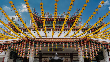 A Chinese Thean Hou Temple on a blue sky background. Details. The roof with curved edges is...