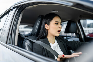 Driving during rush hour But the traffic is very congested. Angry face. Young asian businesswoman has broken down car on the road she feeling serious and stressed. Car crash Look for someone help.