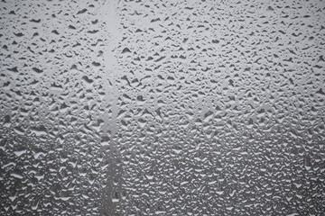 Close-up view of a window covered with raindrops