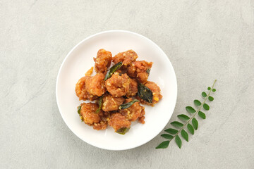 Salted egg fried shrimp or udang telur asin with curry leaves

