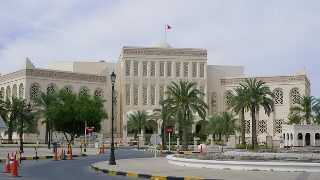 Al Fateh Grand Mosque against sky Manama, Bahrain. Arabian Style Building in city. Palm Trees on footpath by road.
