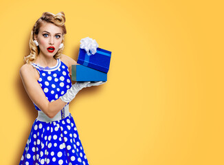 Image of beautiful blond woman wear pin up blue dress in polka dot white gloves open gift box,...