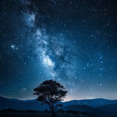 Fototapeta na wymiar A stunning night sky with the Milky Way galaxy visible above a solitary tree on a hill