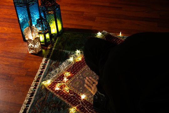 Woman Praying on a Prayer Mat on the Background of Ramadan Lanterns, Uskudar Istanbul, Turkiye (Turkey)