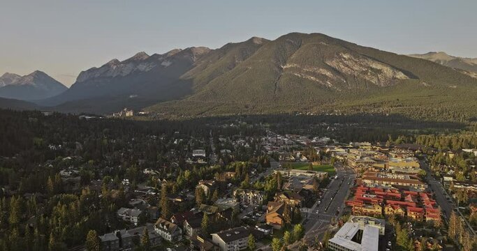 Banff AB Canada Aerial v22 cinematic drone flyover residential area capturing tranquil morning landscape of quaint town and majestic Sulphur mountain ranges - Shot with Mavic 3 Pro Cine - July 2023