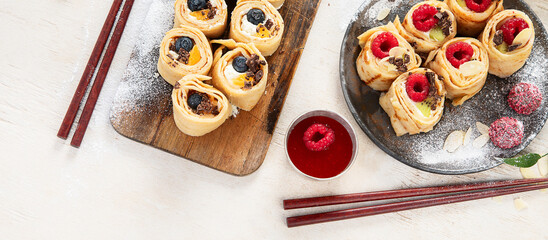 Asian sweet sushi pancake. Rolls with cream cheese berry and fruits.