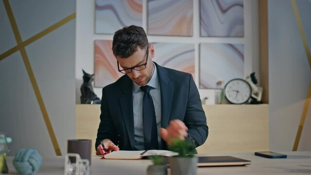 Morning businessman taking notebook starting work day at creative agency closeup