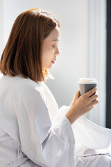 Tranquil Morning coffee, Woman Relaxing at Home with Coffee or Tea in Hand, concept image for coffee or tea drinking, morning hot drink, waking up with style, herbal refreshments drinks