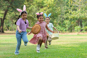 Group of children happily runs around pick up Easter eggs in the park, Easter egg hunt concept, selective focus - obrazy, fototapety, plakaty