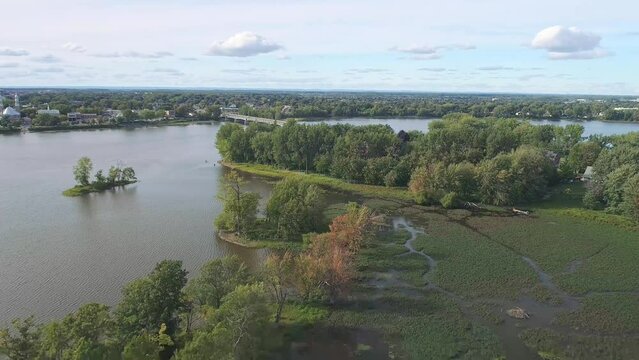 High-altitude, gently descending drone view of the Arthur-Sauv&eacute; Bridge between Laval and St-Eustache in autumn.