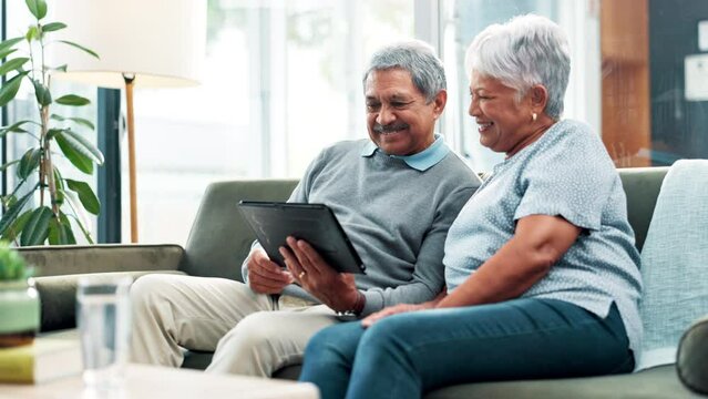 Tablet, couch and senior couple with laugh, social media and game with bonding and care. Retirement, home and streaming on a website or internet in a living room with tech and watching a video