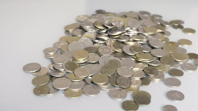 Disorder in finances. Organized coin stacks faced to a pile of disorganized coins
