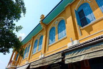 Brightly colored ancient buildings in colonial style in Bangkok, Thailand.