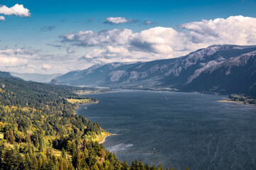Fototapeta na wymiar Birds eye view of the Columbia River Gorge showing its winding banks with forested mountain ranges and low cloudy sky