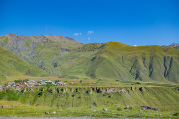 Verdant Majesty: Green Mountains and a Blue Mirage