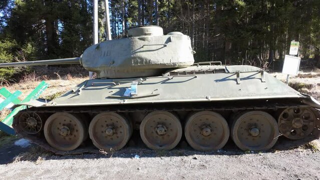 Abandoned Soviet T34 tank at the side of the road on the Austrian Slovenian border from a side view.