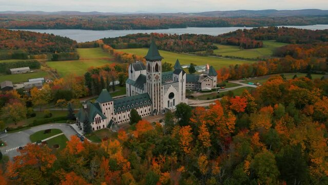 aerial shot over saint benoit du lac abbey near Magog in Quebec province with memphremagog lake in the background during fall, autumn season, Canada