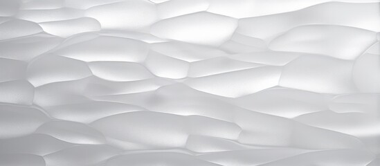 A close up of a white surface with a geometric pattern resembling automotive tire tread design, evoking shades of grey clouds and petallike shapes on a wood flooring canvas