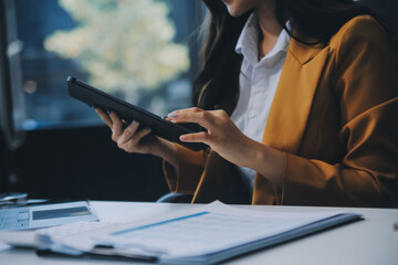 Young attractive businesswoman working on her project with laptop computer in modern office room.