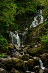 Female tourist at Torc Waterfall in Killarney National Park, County Kerry, Ireland