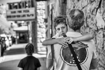 A father carries his son along the streets of Jackson Hole, Wyoming - 756977646