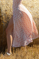 Beautiful legs of a girl dress in a field with hay - 756980243