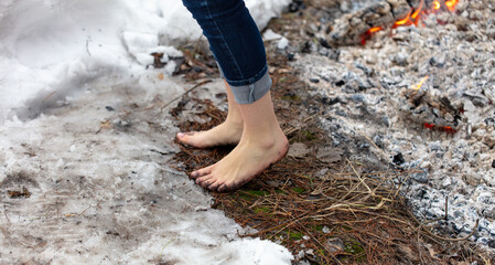People warm their feet by the fire in winter - 756980840