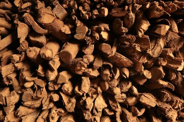 A pile of stacked firewood, prepared for heating the house, Firewood harvested for heating in winter, Chopped firewood on a stack, Firewood stacked and prepared for winter Pile of wood logs