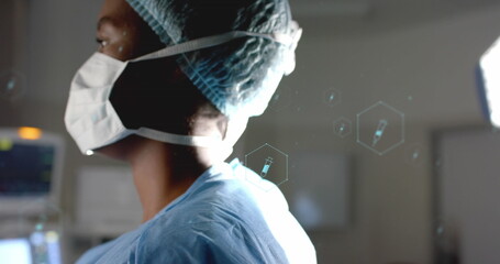 Image of network of medical icons and data processing over african american female surgeon
