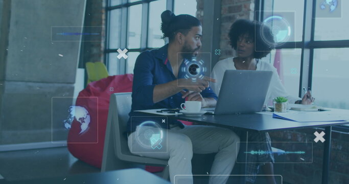 Image of digital interface with icons over biracial couple using technology