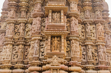 Stone carved sculptures on the outer wall of the Devi Jagdamba temple, Western group of monuments, Khajuraho, Madhya Pradesh, India, Asia.