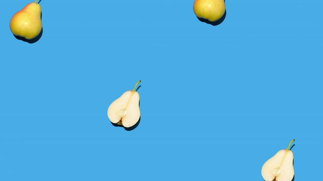 Stop motion animation of pears with shadows filling the blue background one by one and then reverse. A modern look with many conceptual interpretations. 