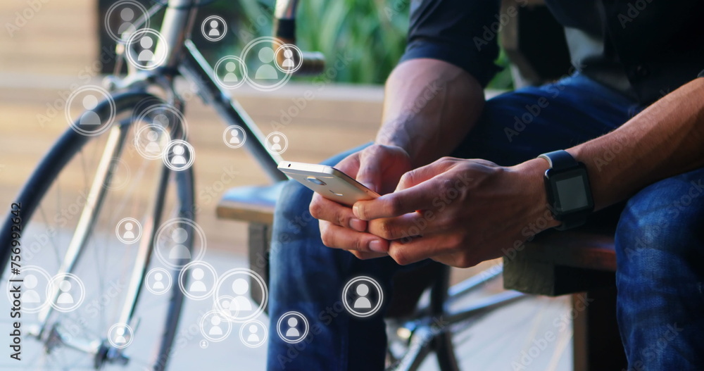 Poster a low angle view of a man using a mobile phone with a bicycle on his right