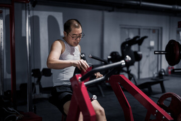 Fototapeta na wymiar Men exercise their arm muscles in the gym