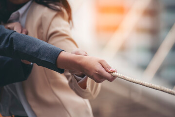 Tug of war Businesswoman Team holding hands together partnership leader teamwork. Group of business people Hands pulling rope symbol team unified teamwork Partnership Concept. diversity competition