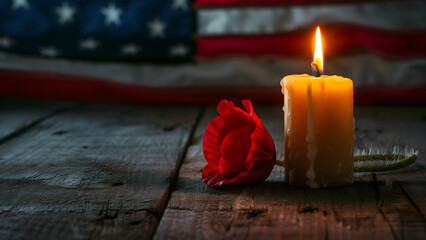 Red poppy and candle against USA flag in honor of Memorial Day with copy space on the left. 