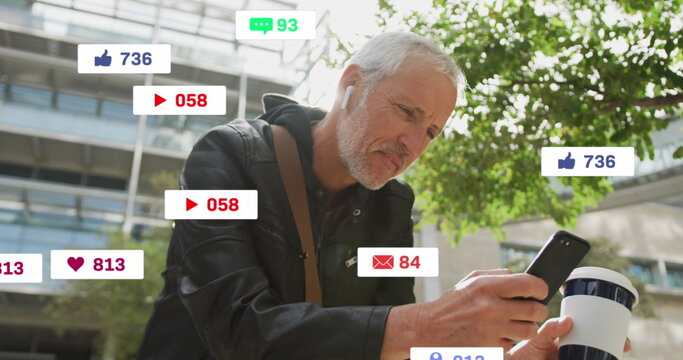 Image of social media icons over senior man using smartphone - Powered by Adobe