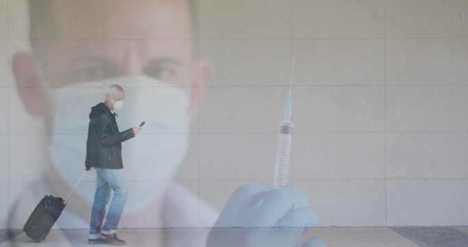 Image of doctor with covid 19 vaccine over senior man wearing face mask - Powered by Adobe