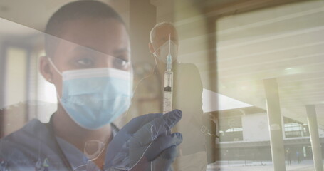 Image of female doctor with covid 19 vaccine over senior man wearing face mask