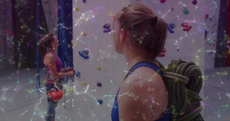 Image of data processing over caucasian women climbing wall