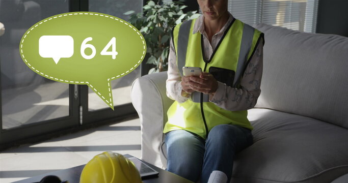 Female worker in safety vest texts on couch, message count visible.